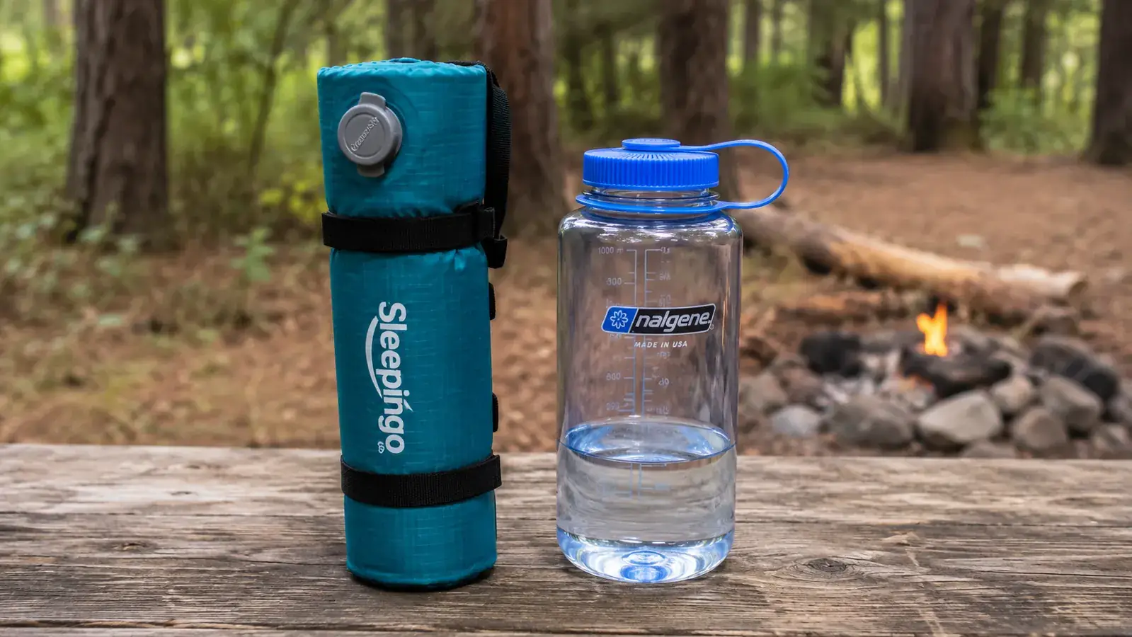 Rolled Sleepingo sleeping pad next to a water bottle for size comparison
